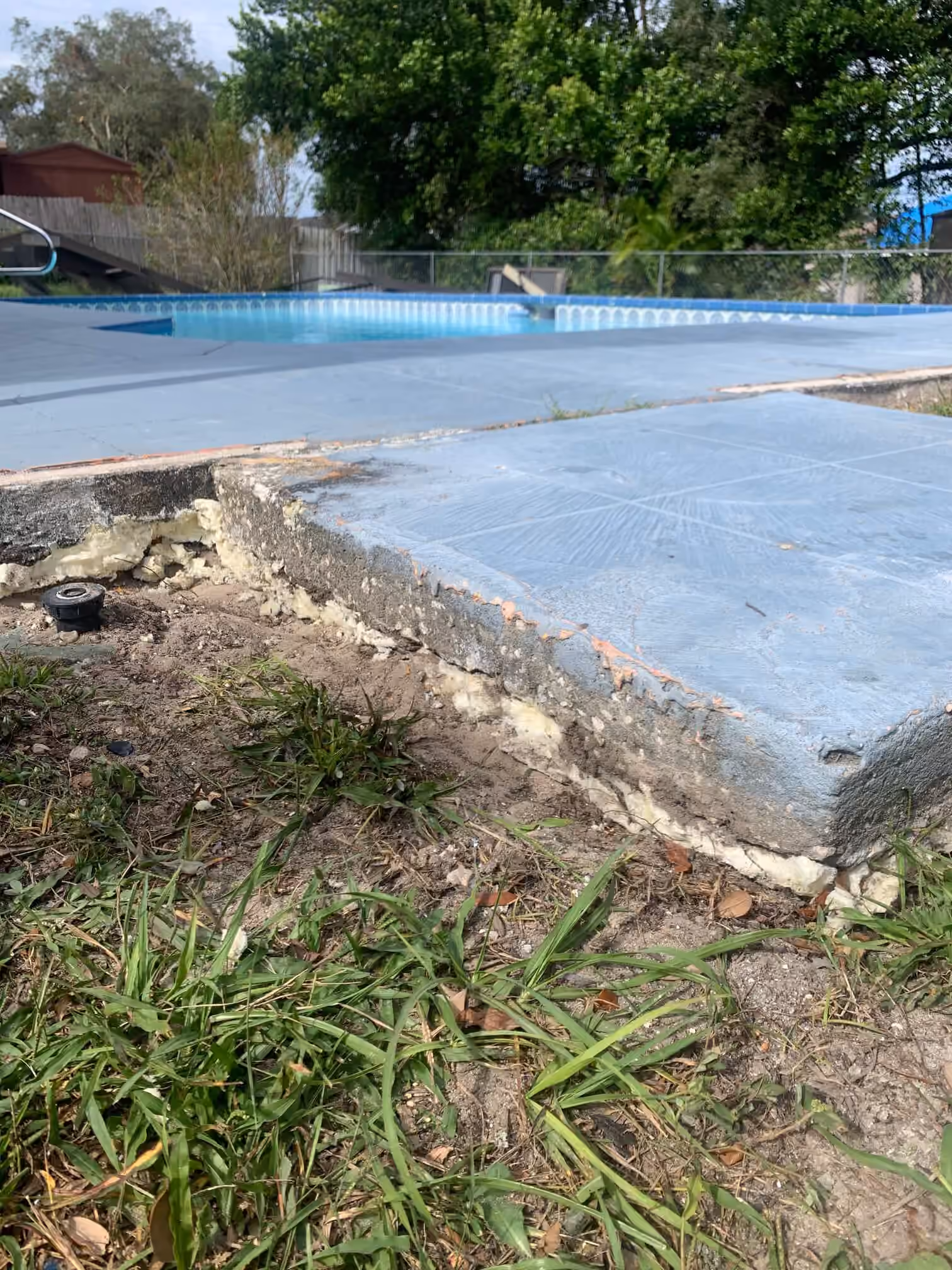 Pool deck slab with polyurethane foam filling the void underneath